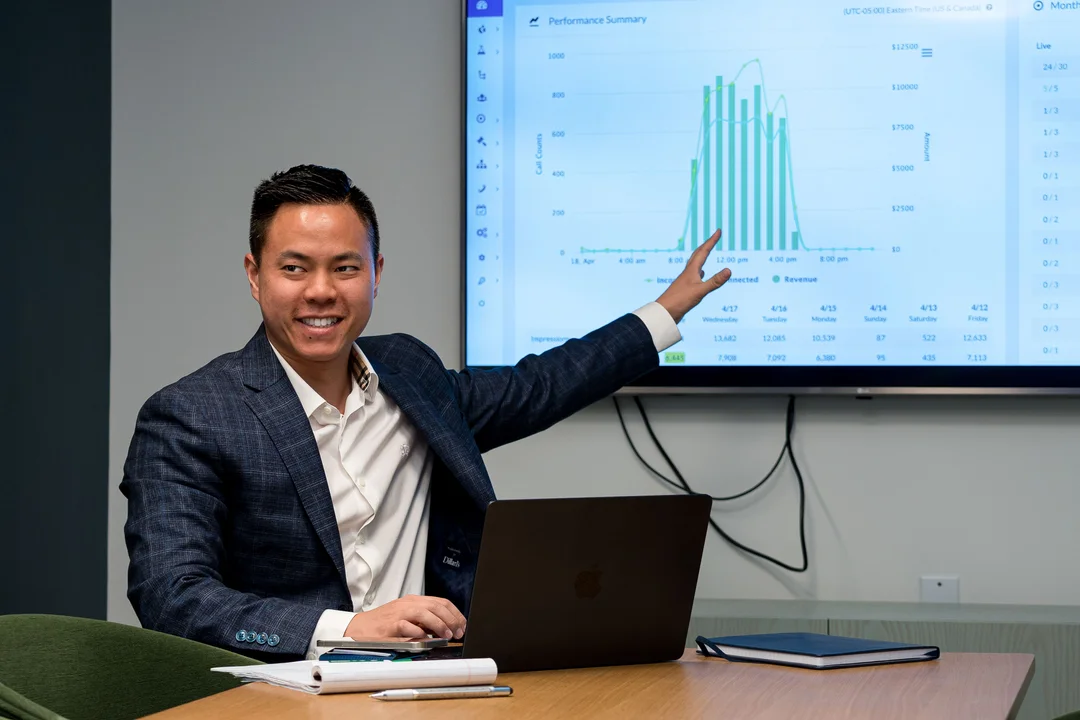 Ringba User Stories - Teddy Truong in a Meeting and Pointing at Pay Per Call Stats
